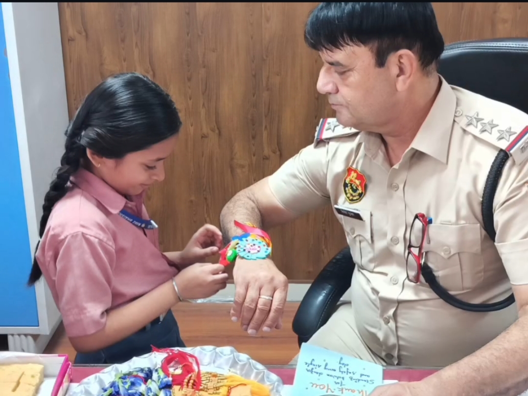 A Thread of Respect: A student tying a Rakhi to a police officer, honoring their unwavering commitment to our safety.